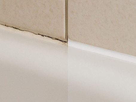 Erneuerung von Silikonfugen rund um die Badewanne mit schimmelresistentem, weißem Silikon, das präzise aufgetragen