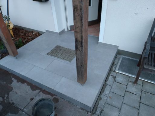 Gefliester Podest und Treppenstufe im Eingangsbereich des Hauses