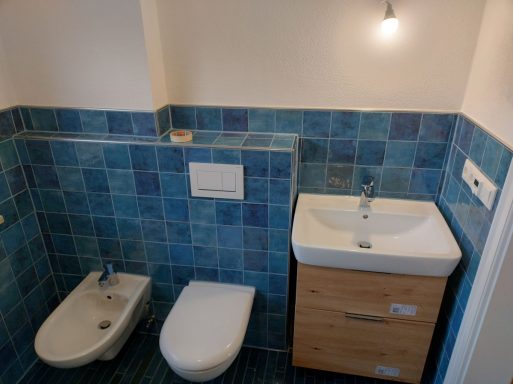 Waschtischbereich im Bad mit kleinen blauen Fliesen